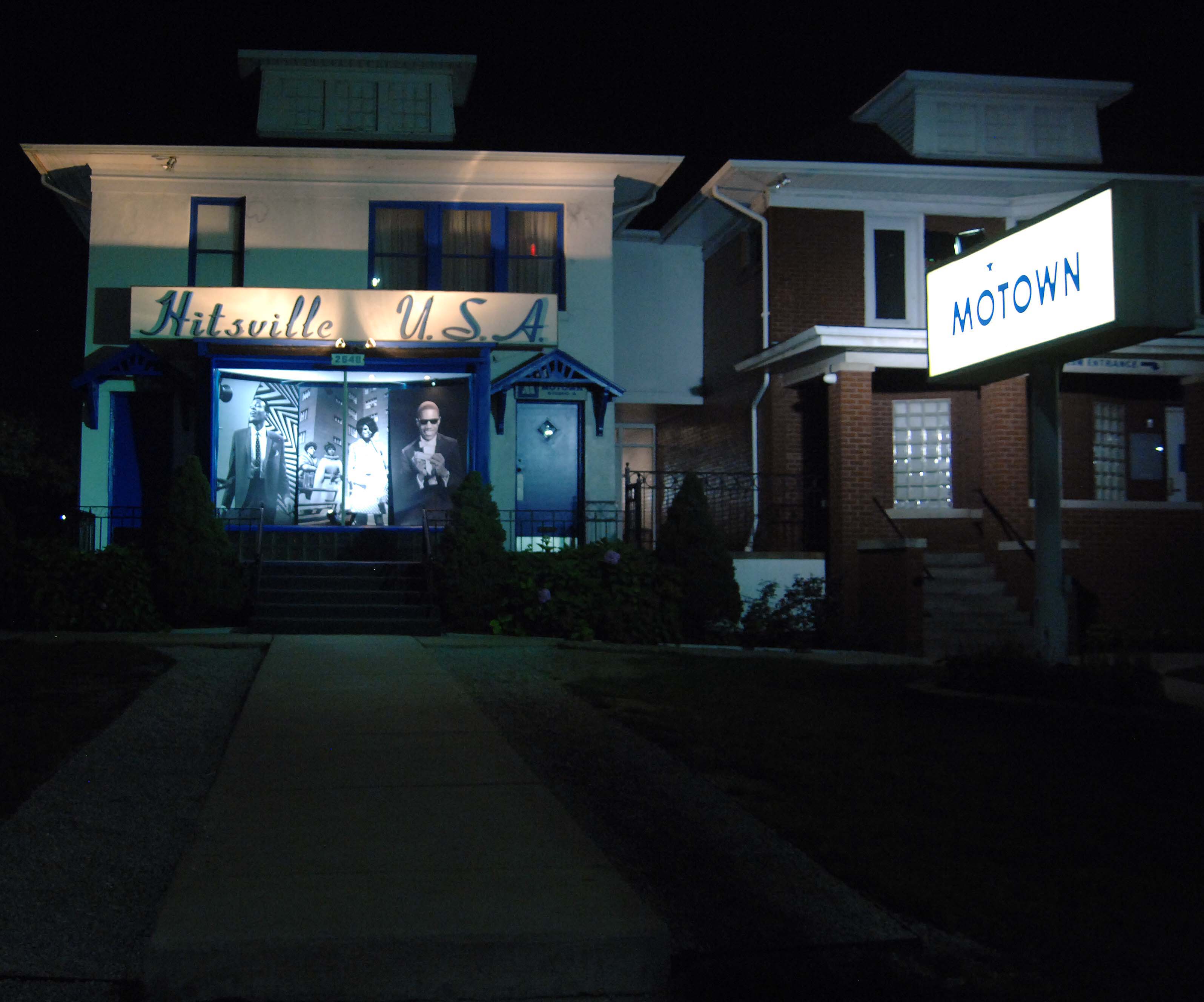 An archival nighttime photograph of Hitsville U.S.A. and the illuminated Motown Museum sign