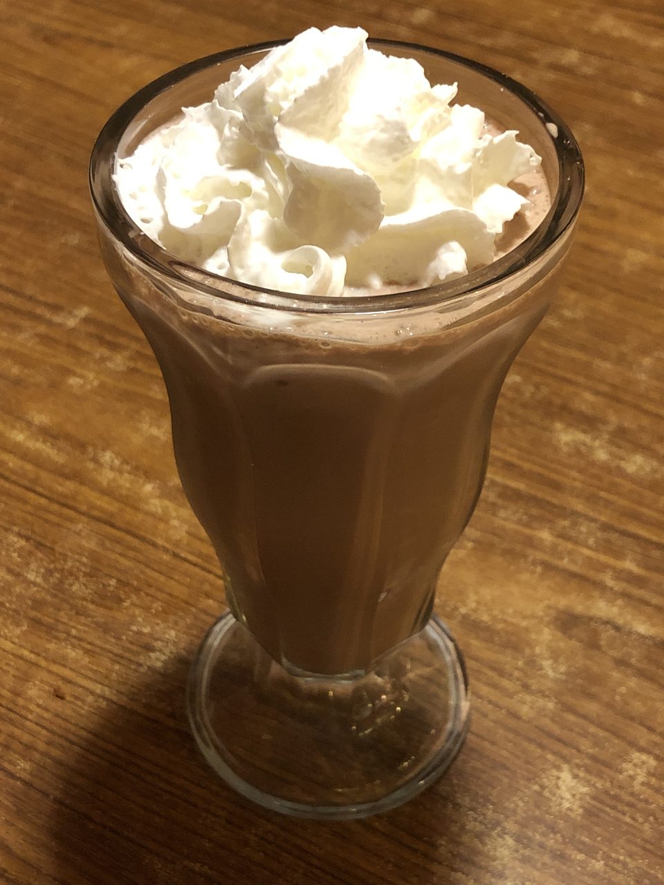 A chocolate milkshake with whipped cream