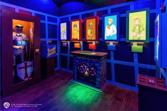 Scooby-Doo-szoba lovagi páncéllal, a banda tagjainak portréival és világító kandallóval