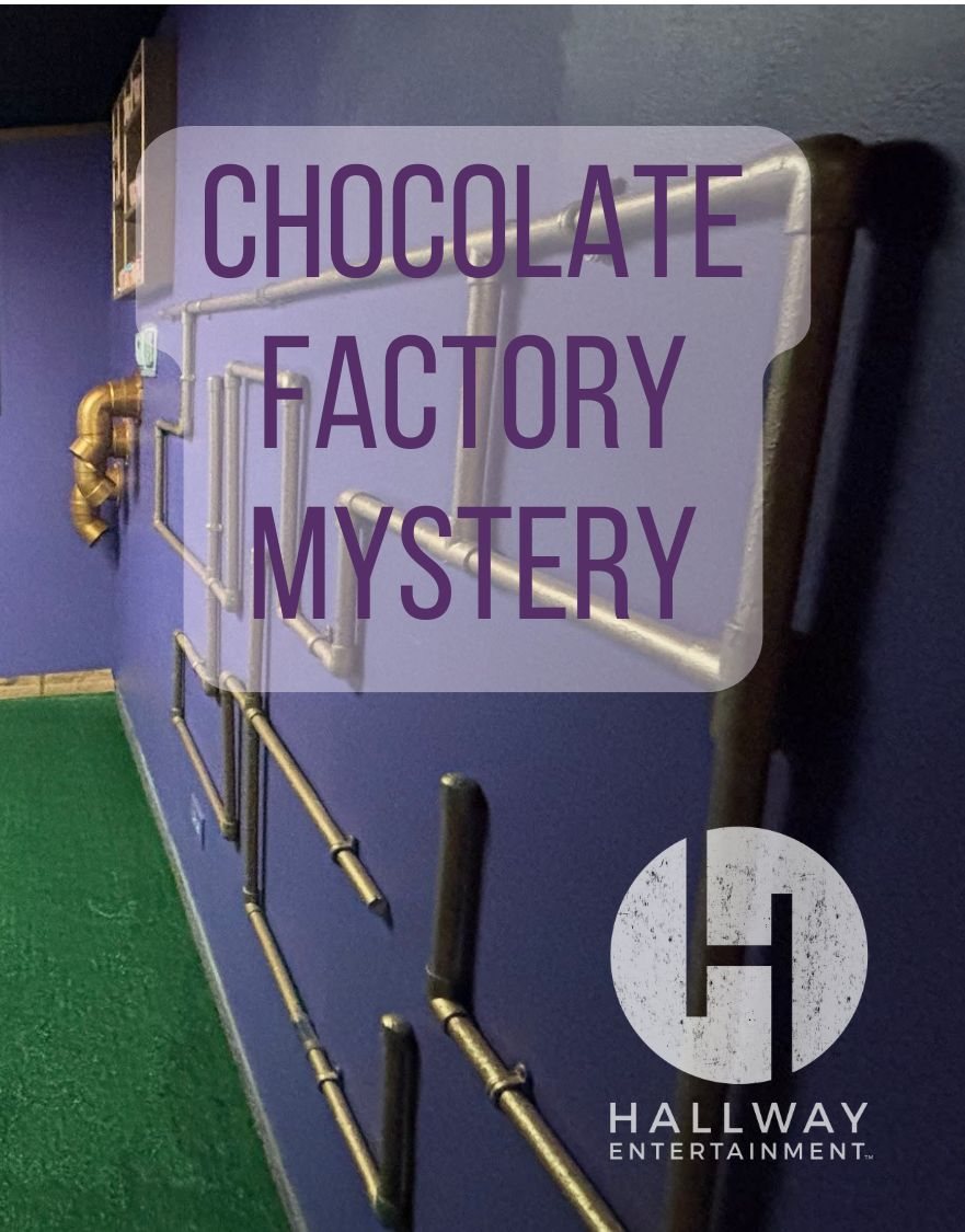 Painted pipework running along a purple wall above green artificial turf in the Chocolate Factory Mystery room