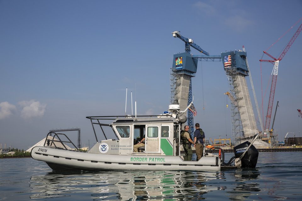 A Border Patrol boat in front of the rising tower legs, 2021