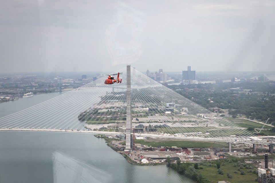 A Coast Guard helicopter over the bridge and downtown, 2025