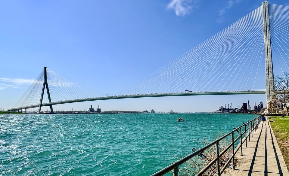 The bridge from the riverside railing, 2026