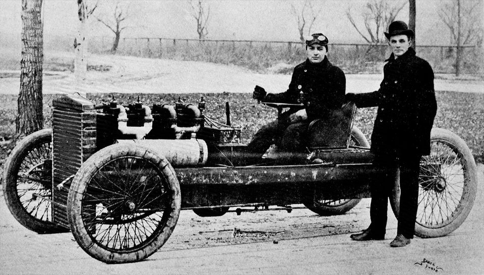 Henry Ford (standing) and Barney Oldfield with the 999 race car in 1902