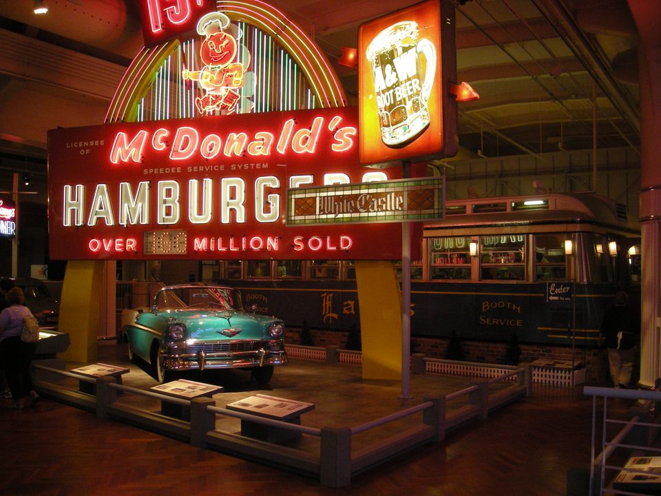 Early McDonald’s, A&W and White Castle signs, a 1950s Chevrolet and Lamy’s Diner behind them in the Driving America exhibit (2012)