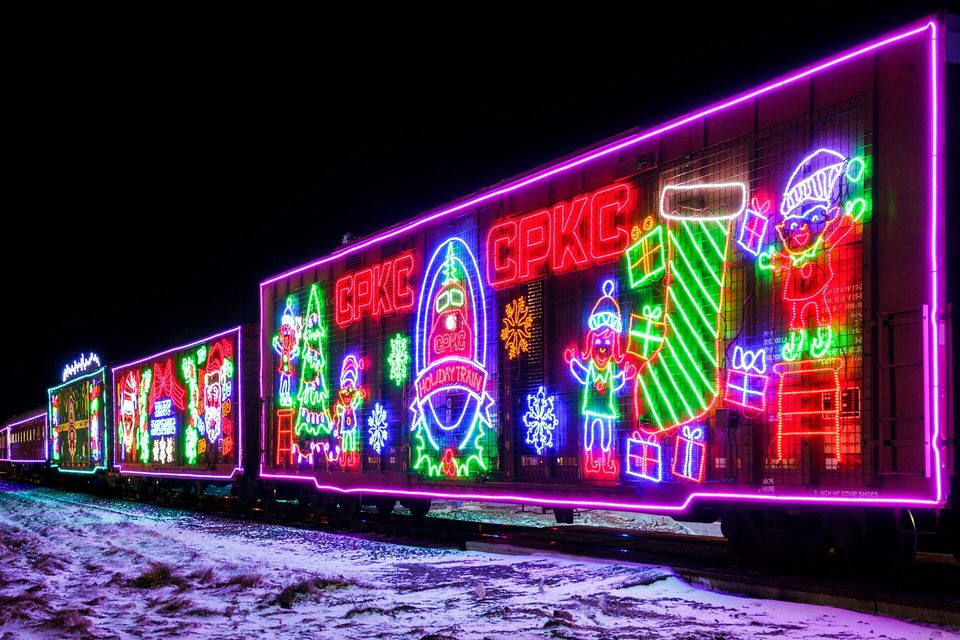 The lit boxcars of the CPKC Holiday Train in Minneapolis, 2023