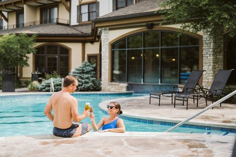 The outdoor pool in front of the lodge's glass-walled facade