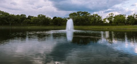 A pond with a fountain on the campground