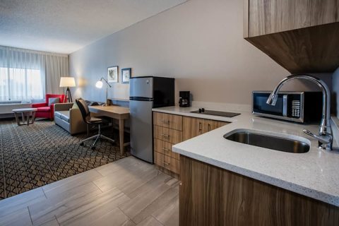 A kitchenette with a sink and a desk