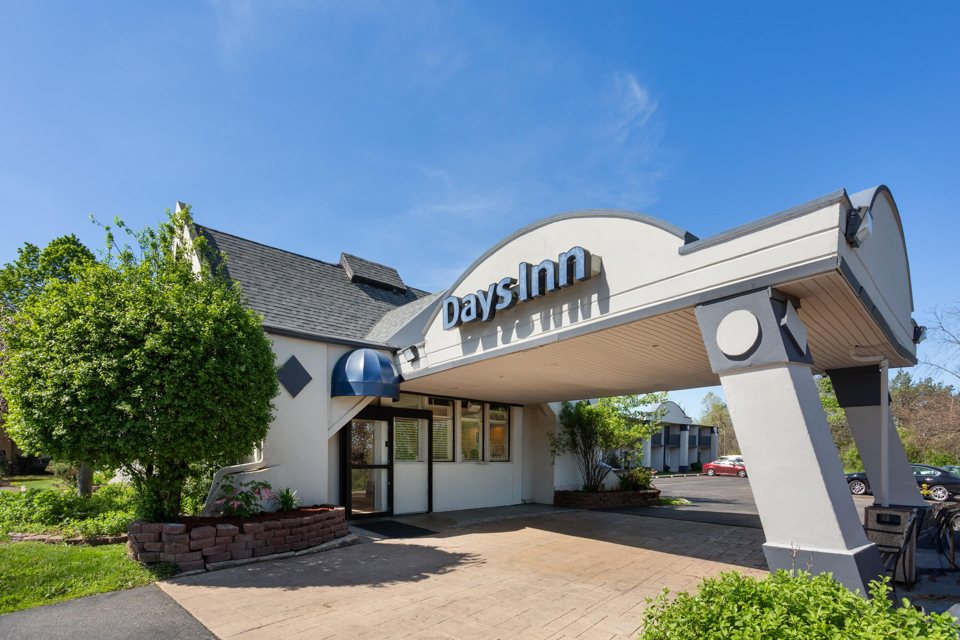 The hotel's curved entrance canopy with its sign