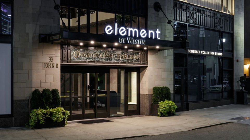 The Element hotel entrance on the Metropolitan Building facade at night