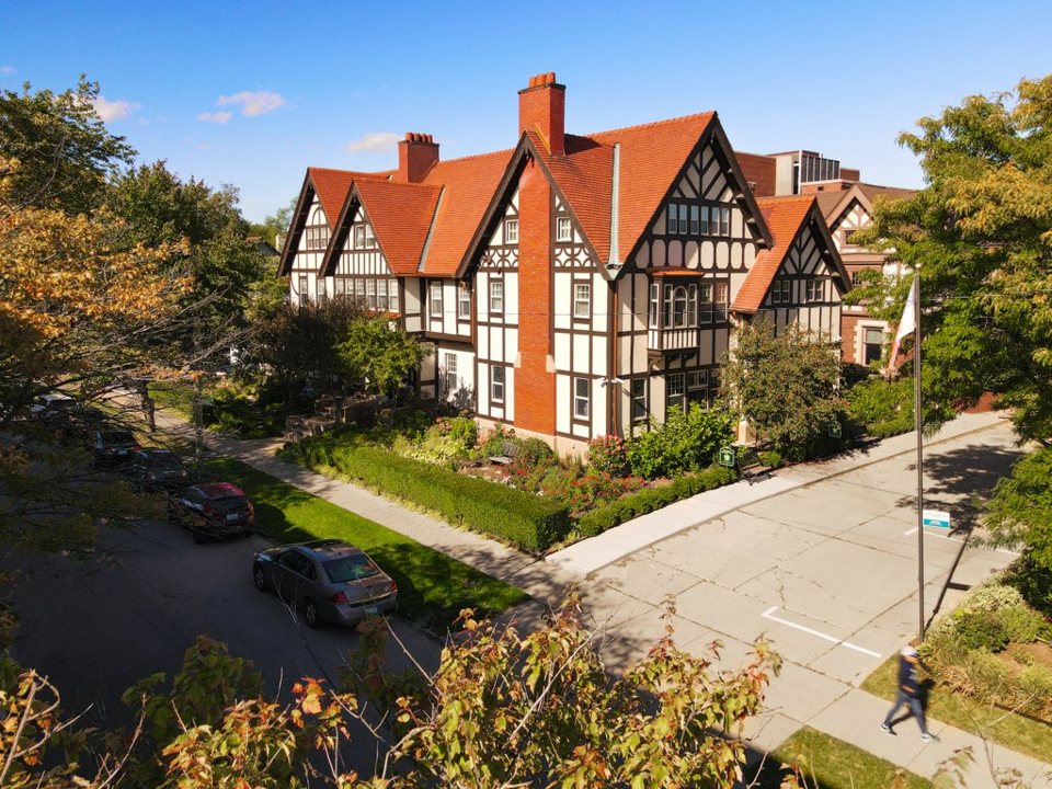 The Frederick Stearns House's Tudor-style facade with red roofs seen from above, with autumn trees