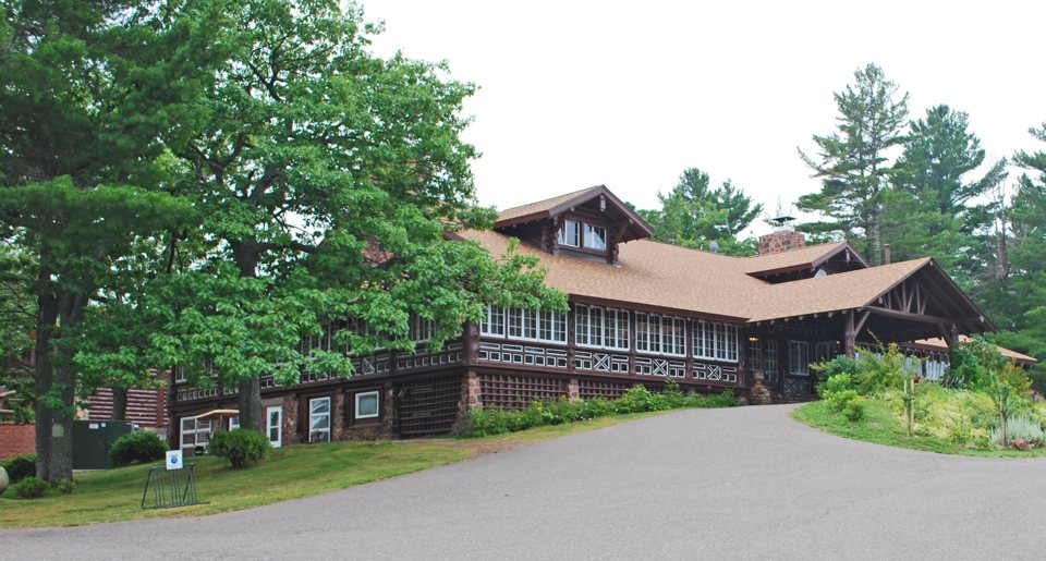The log-walled main building of Keweenaw Mountain Lodge among the trees