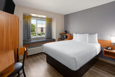 A guest room with a bed and a desk