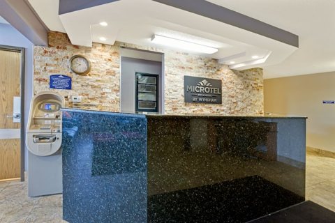 The front desk with a stone-clad wall