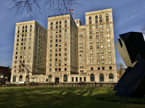 The Park Shelton facade seen from the lawn beside the Detroit Institute of Arts, with a black sculpture in the foreground, 2020