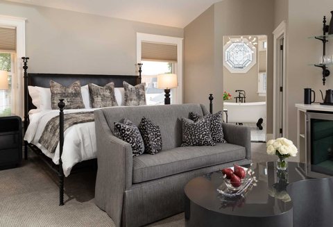 A guest room with a bed and a sofa