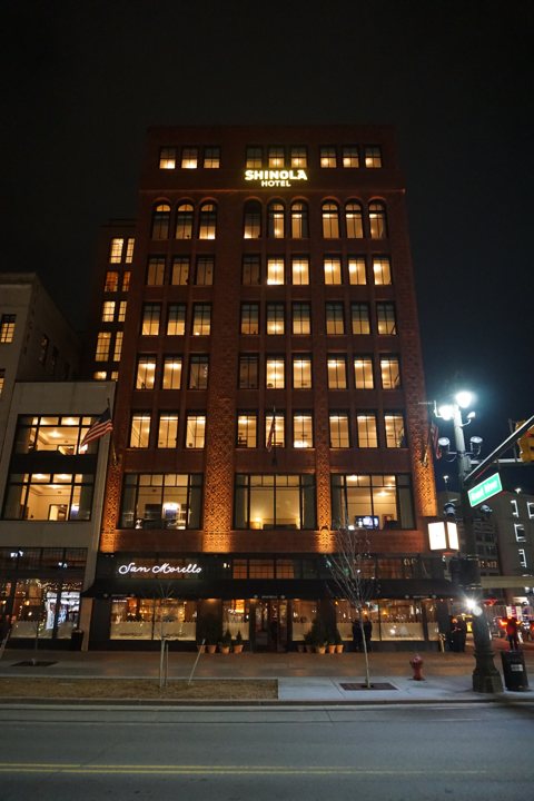 The lit Shinola Hotel at night with San Morello restaurant on the ground floor, December 2018