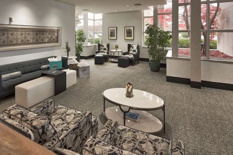 The lobby with sofas, armchairs and large windows