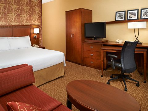 Guest room with a bed and desk