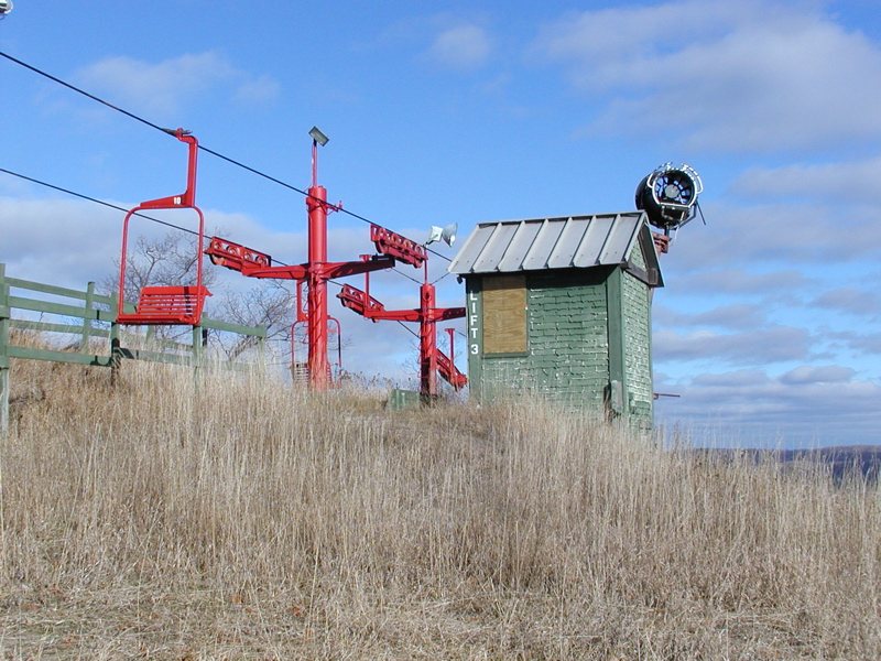 The idle Sugar Loaf ski hill's red chairlift and small wooden hut in 2003