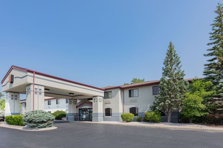 The motel building with pine trees