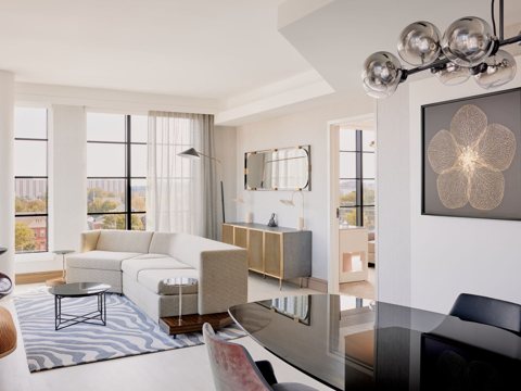 The bright living room of the presidential suite with a sectional sofa and a dining table