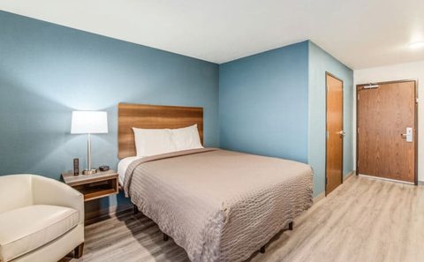 Guest room with a bed and blue wall