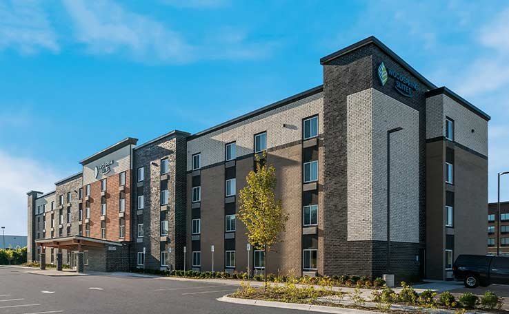 The four-storey hotel building under blue sky