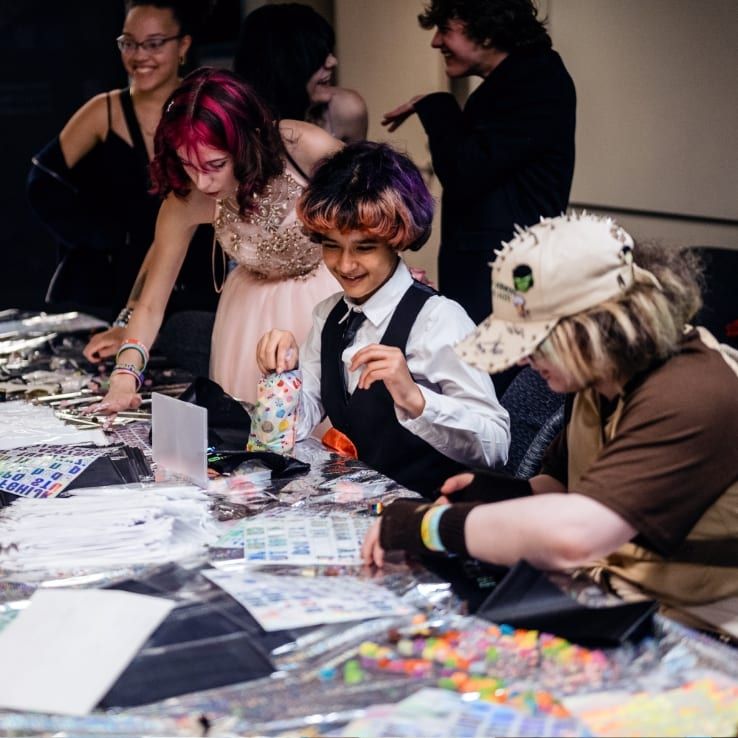 Young people doing crafts together at a table