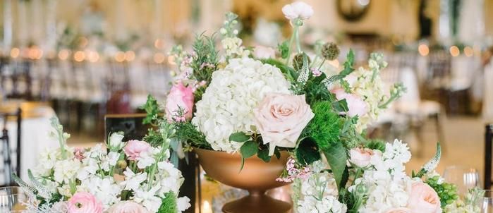 Rose and hydrangea centerpiece in a copper urn