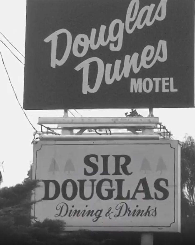 Vintage black-and-white photo of the Douglas Dunes Motel and Sir Douglas sign