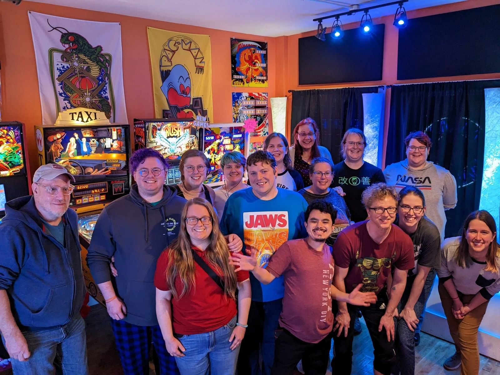 Group photo of attendees at a GIFT event with pinball machines behind them