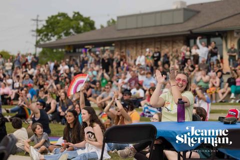 Cheering crowd at Grand Haven PrideFest in a park