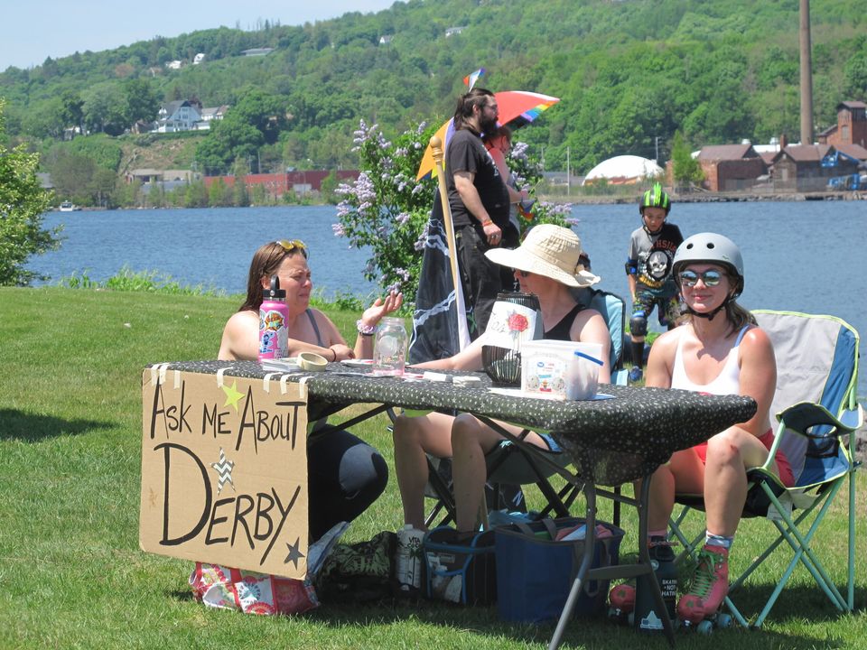 Info table with an 'Ask me about Derby' sign by the water