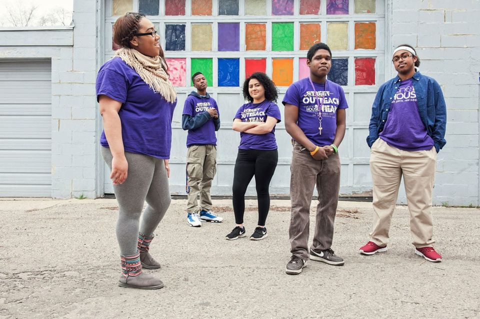 Ozone House street outreach team in purple shirts by a colorful wall
