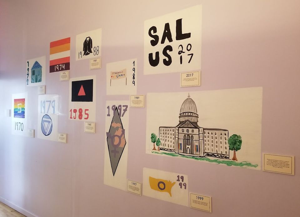 Timeline exhibit on a wall, including a “Salus 2017” panel