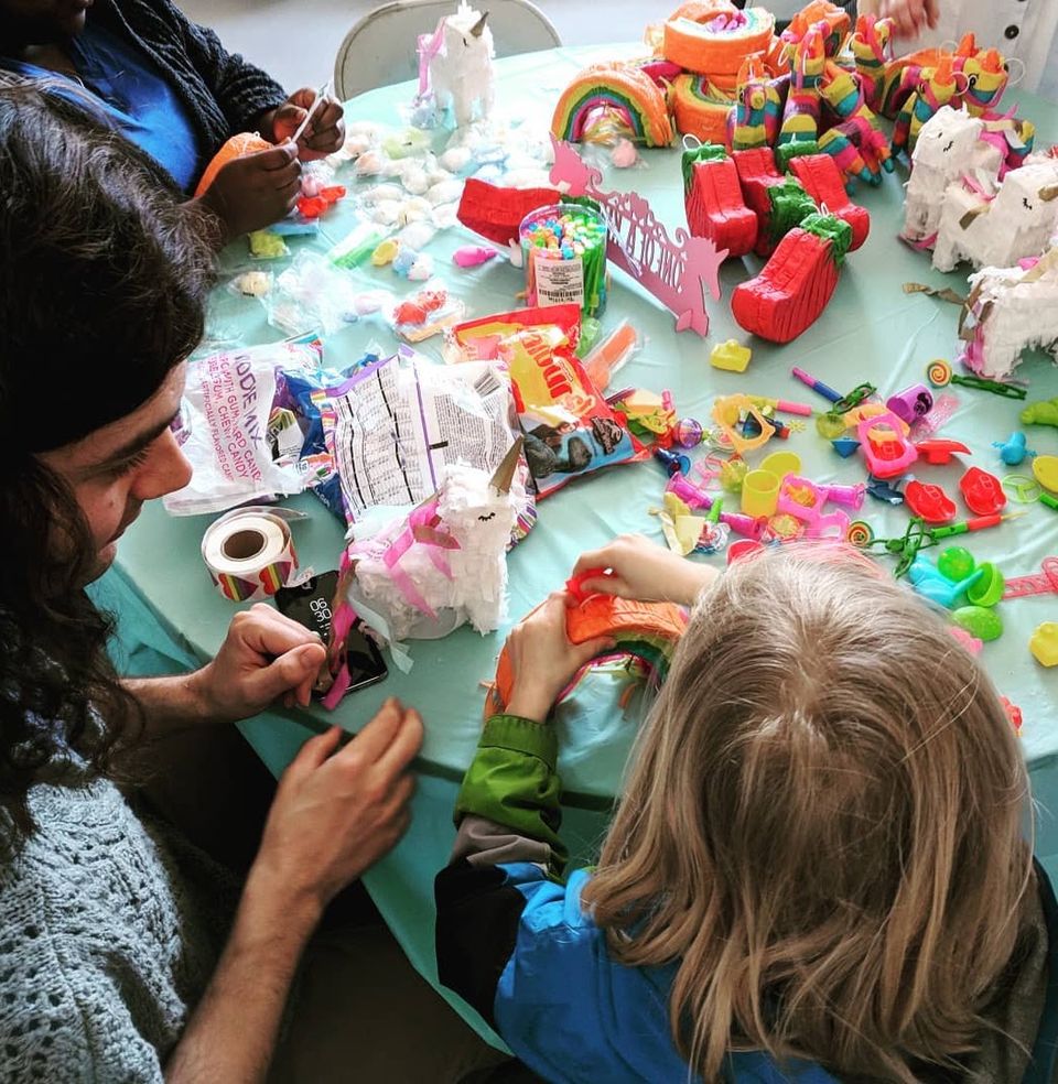 Craft activity: decorating colorful toy figures at a table