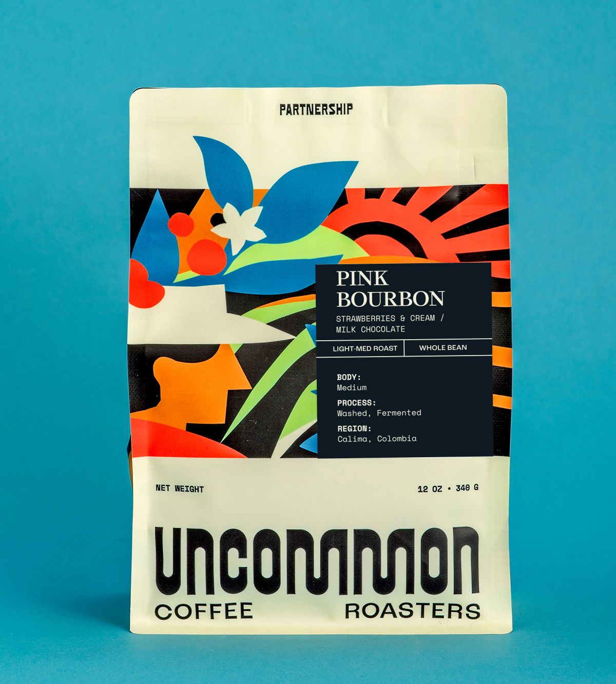 Uncommon Coffee Roasters Pink Bourbon coffee bag on a teal background