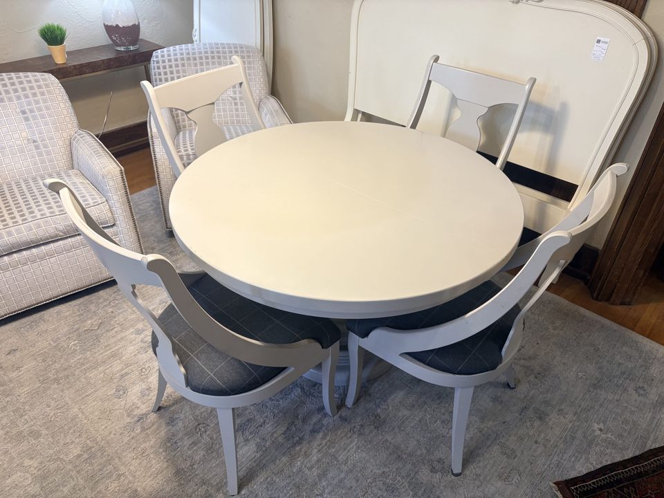 Cream round dining table with chairs in the store