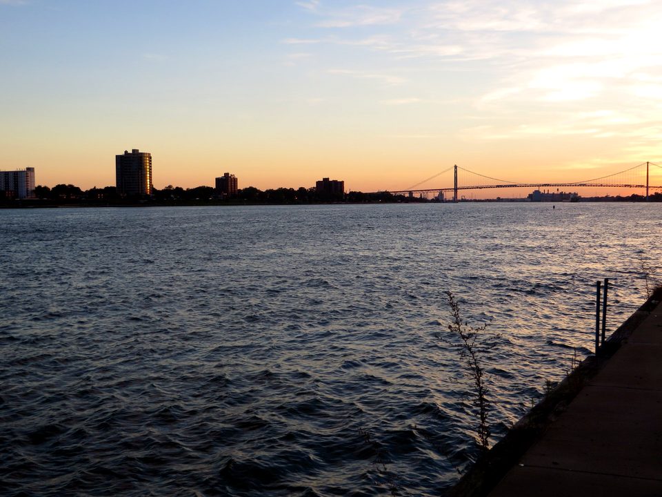 The Detroit River at sunset with the Ambassador Bridge