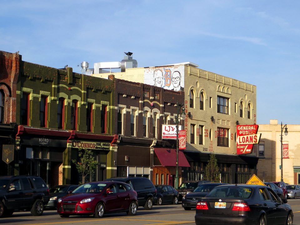 A row of old storefronts with painted signs on Michigan Avenue