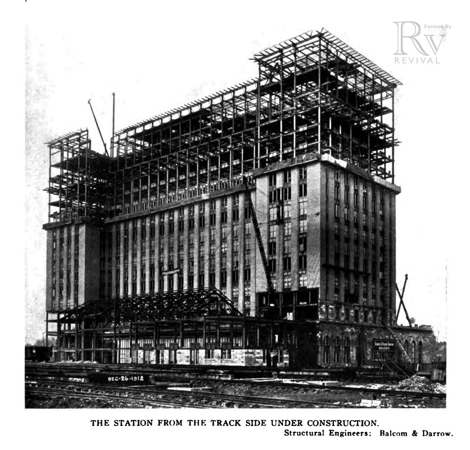 The tower’s steel frame rising behind the waiting room, 1913