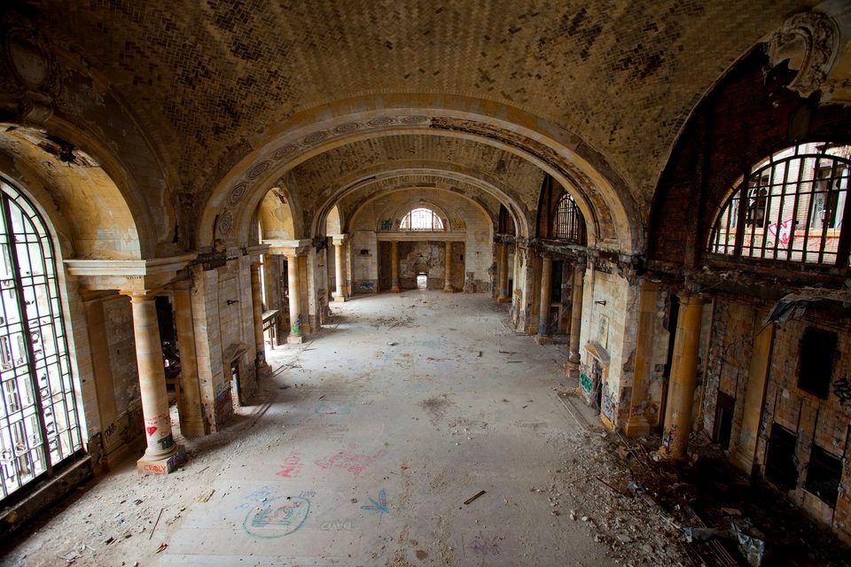 The stripped main waiting room with broken windows and debris, 2009