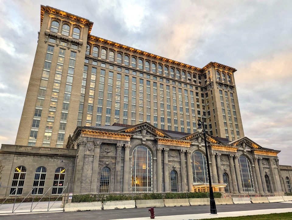 The restored facade at dusk with glowing windows, 2023