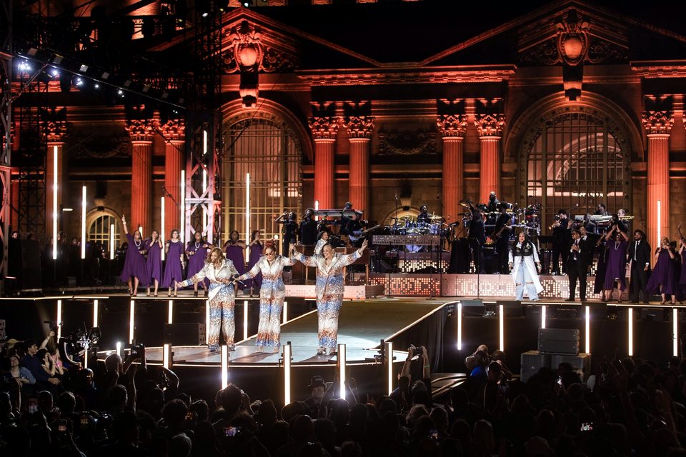 The facade glowing orange during the concert, 2024
