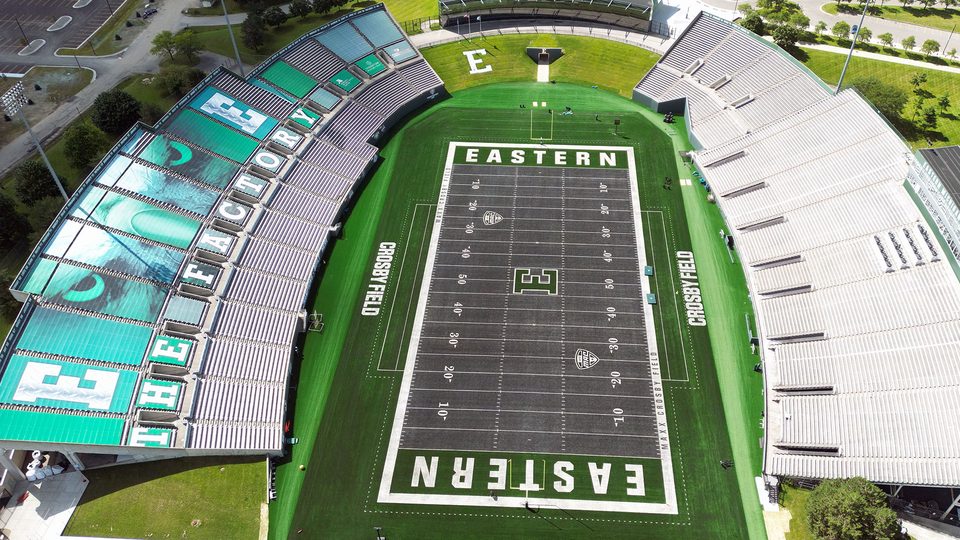 Rynearson Stadium from a drone, with The Factory lettering on the stands and EASTERN in the end zones