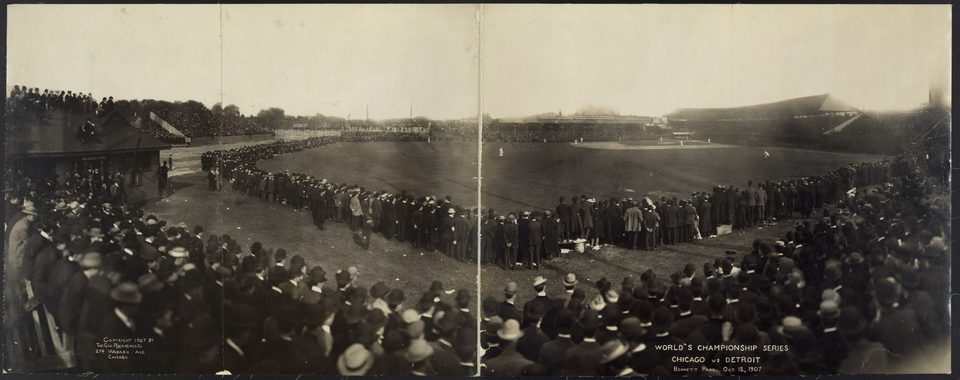 Vintage panoramic photo of Bennett Park during the 1907 World Series, with crowds standing along the field