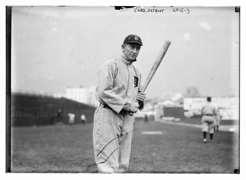 Ty Cobb in a Detroit uniform holding a bat on a ballfield, from a glass-plate negative