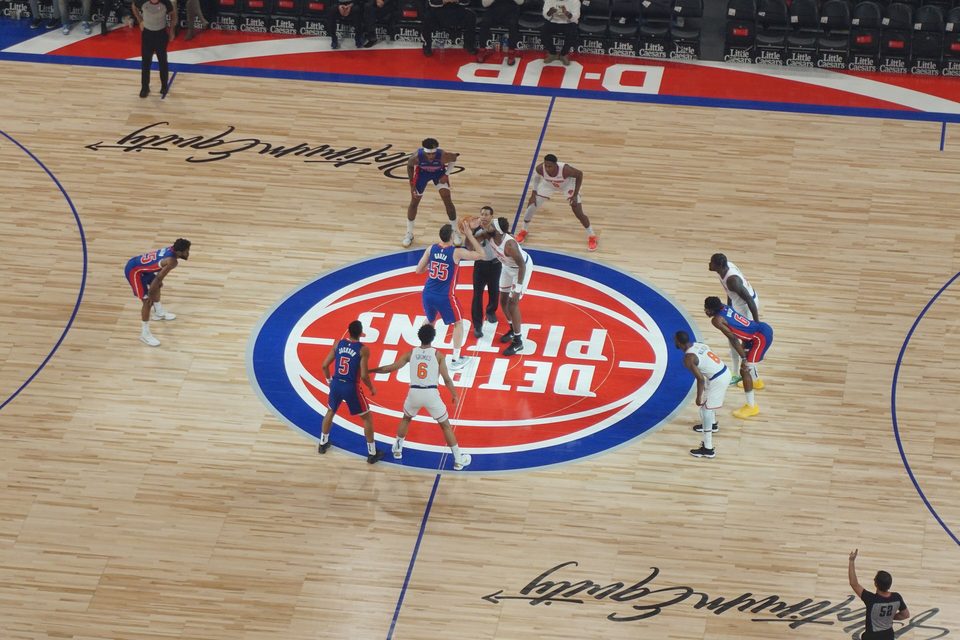 Opening tip over the Pistons logo at center court in Little Caesars Arena, seen from above